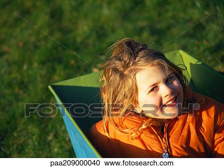 Child sitting in box, smiling. View Large Photo Image Stock Image - Child sitting in box, smiling.. Fotosearch