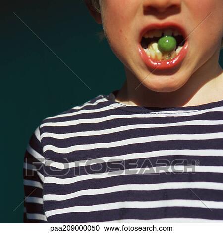 Child with mouth open holding candy between teeth, close-up. View Large Photo Image Stock Image - Child with mouth open holding candy between teeth, close-up.. Fotosearch
