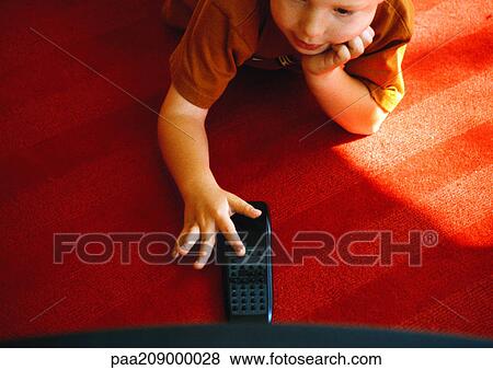 Child with remote control View Large Photo Image Stock Photo - Child with remote control. Fotosearch