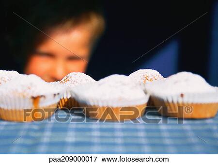 Stock Photo - Cookies on table, child in background. . Fotosearch