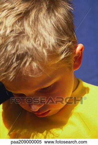 Little boy looking down, portrait. View Large Photo Image Stock Photography - Little boy looking down, portrait.. Fotosearch