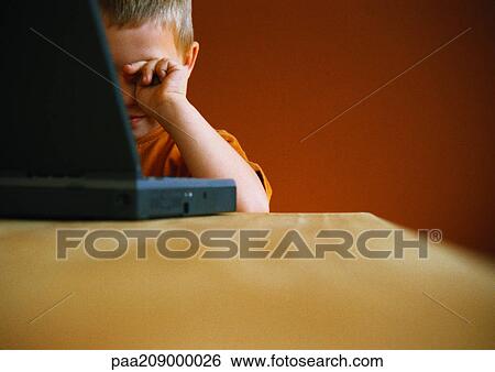 Little boy with laptop, rubbing eyes. View Large Photo Image Stock Photograph - Little boy with laptop, rubbing eyes.. Fotosearch