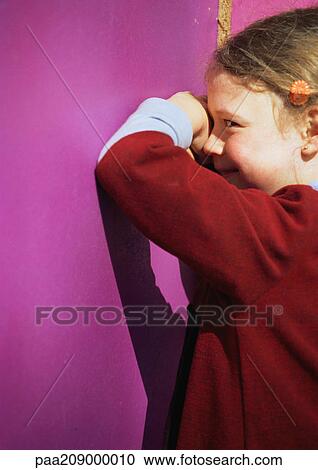 Little girl facing wall, smiling. View Large Photo Image Stock Image - Little girl facing wall, smiling.. Fotosearch