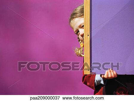 Little girl hiding behind chalkboard. View Large Photo Image Stock Photo - Little girl hiding behind chalkboard.. Fotosearch