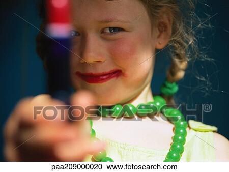 Little girl holding out lipstick, close-up. View Large Photo Image Stock Image - Little girl holding out lipstick, close-up.. Fotosearch