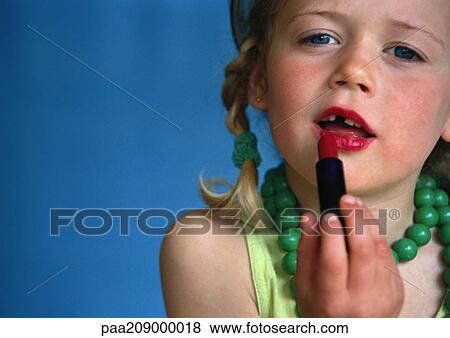 Little girl putting on lipstick, close-up. View Large Photo Image Stock Photo - Little girl putting on lipstick, close-up.. Fotosearch