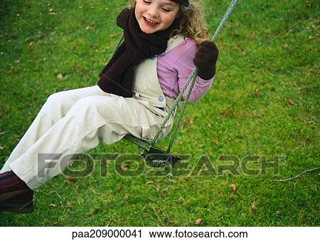 Little girl smiling on swing. View Large Photo Image Stock Image - Little girl smiling on swing.. Fotosearch