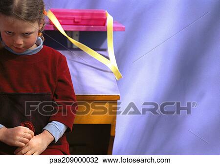 Little girl standing in front of desk, looking up at camera View Large Photo Image Stock Image - Little girl standing in front of desk, looking up at camera. Fotosearch