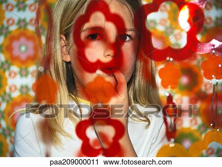 Stock Image - Little girl with finger in her mouth.. Fotosearch