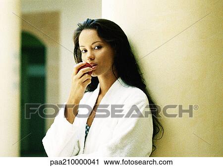Stock Image - Woman eating apple.. Fotosearch
