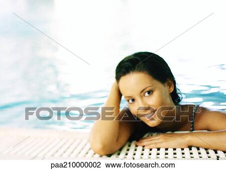 Woman in a swimming pool, smiling. View Large Photo Image Stock Image - Woman in a swimming pool, smiling.. Fotosearch