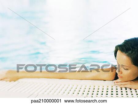 Stock Image - Woman in a swimming pool.. Fotosearch