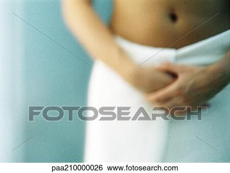 Woman with bath towel around waist, mid section View Large Photo Image Stock Photograph - Woman with bath towel around waist, mid section. Fotosearch