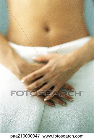 Woman with bath towel around waist, hands crossed, mid-section View Large Photo Image Stock Photo - Woman with bath towel around waist, hands crossed, mid-section. Fotosearch