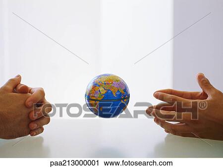Globe between two pairs of clasped hands View Large Photo Image Stock Image - Globe between two pairs of clasped hands. Fotosearch