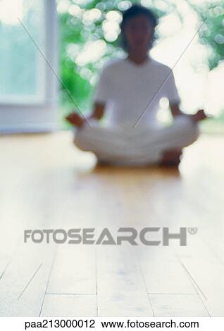 Person meditating in lotus position on floor, blurred View Large Photo Image Stock Image - Person meditating in lotus position on floor, blurred. Fotosearch