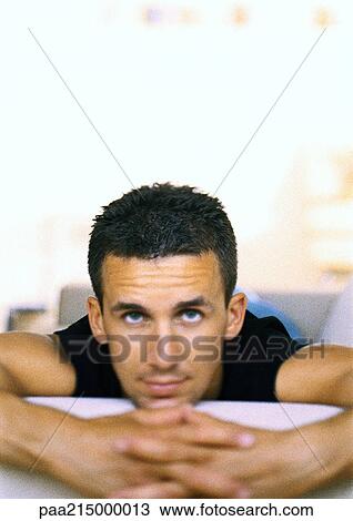 Man, looking into camera, clasped hands in foreground View Large Photo Image Stock Image - Man, looking into camera, clasped hands in foreground. Fotosearch