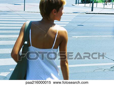 Woman crossing street, rear view. View Large Photo Image Stock Photography - Woman crossing street, rear view.. Fotosearch