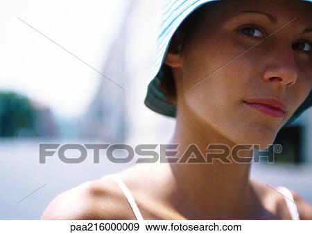 Stock Photo - Woman looking at camera, close-up.. Fotosearch