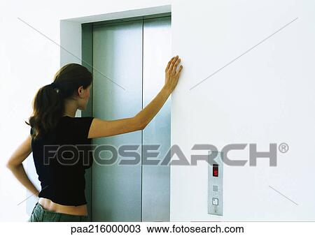 Woman waiting for elevator, rear view. View Large Photo Image Stock Image - Woman waiting for elevator, rear view.. Fotosearch