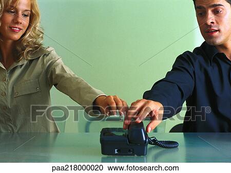 Couple reaching for telephone. View Large Photo Image Stock Image - Couple reaching for telephone.. Fotosearch