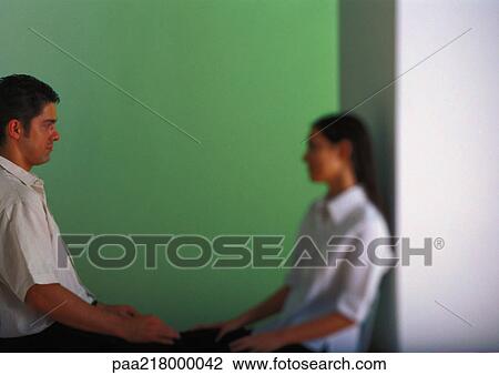 Couple sitting face to face, side view View Large Photo Image Stock Image - Couple sitting face to face, side view. Fotosearch