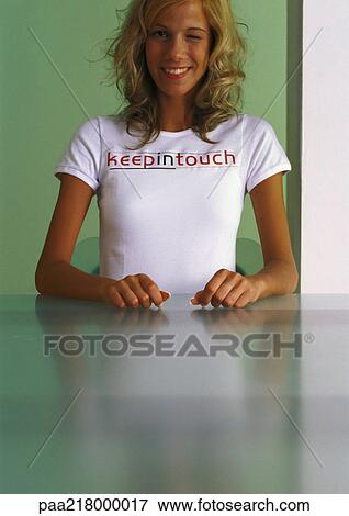 Woman wearing "keep in touch" t-shirt, winking and smiling. View Large Photo Image Stock Photo - Woman wearing "keep in touch" t-shirt, winking and smiling.. Fotosearch