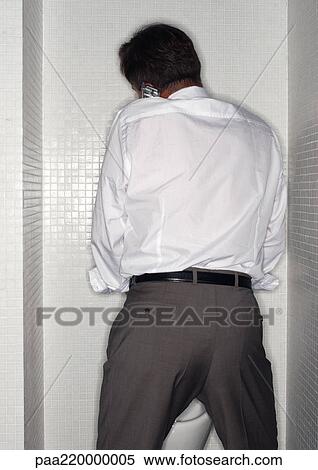 Man using cell phone in toilet. View Large Photo Image Stock Photography - Man using cell phone in toilet.. Fotosearch