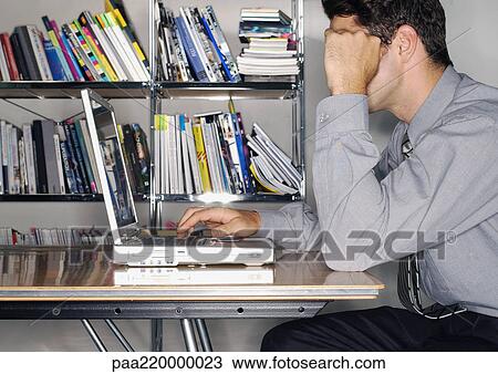 Man using laptop in office, side view. View Large Photo Image Stock Image - Man using laptop in office, side view.. Fotosearch