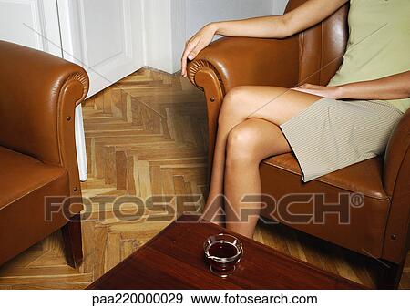 Stock Photo - Woman sitting with coffee in front of her.. Fotosearch