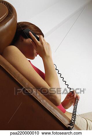 Woman using telephone, low angle view View Large Photo Image Stock Image - Woman using telephone, low angle view. Fotosearch