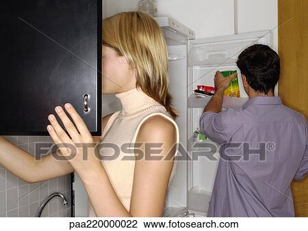 Young couple in the kitchen. View Large Photo Image Stock Image - Young couple in the kitchen.. Fotosearch