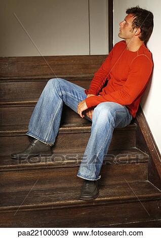 Man sitting on stairs View Large Photo Image Stock Photo - Man sitting on stairs. Fotosearch