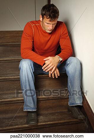 Man standing on stairs, bending head View Large Photo Image Stock Photo - Man standing on stairs, bending head. Fotosearch