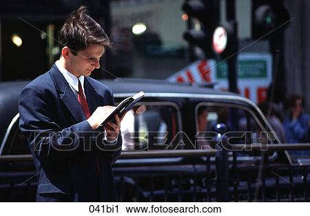 Businessman Reading a Guide book in the Street View Large Photo Image Stock Image - Businessman Reading a Guide book in the Street. Fotosearch