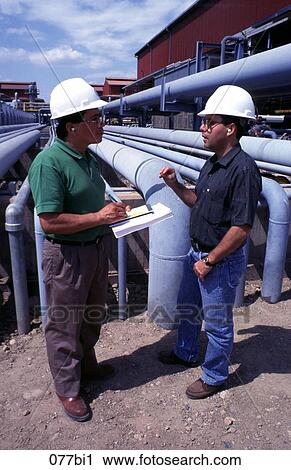 Stock Image - Oil Refinery Management Talking on Site. Fotosearch