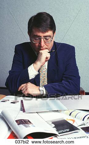 Businessman Reading Report at Desk View Large Photo Image Stock Image - Businessman Reading Report at Desk. Fotosearch
