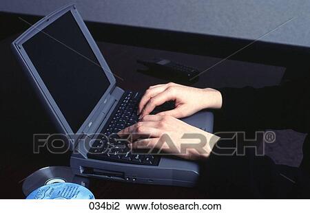 Stock Image - Close-up of Woman Working at a Laptop Computer. Fotosearch