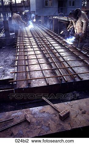 Stock Image - Welders Assembling Steel Rods Moscow Russia. Fotosearch