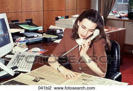 Woman Sitting at Desk Talking on Phone View Large Photo Image Stock Image - Woman Sitting at Desk Talking on Phone. Fotosearch