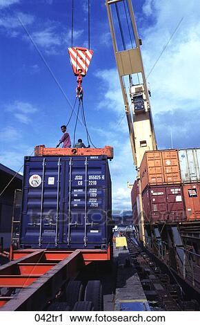 Stock Image - Containers being Loaded onto a Lorry at Quayside The Philippines. Fotosearch