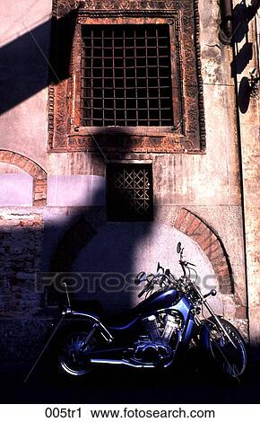 Stock Image - Motorbike against an Old Wall Milan Italy. Fotosearch