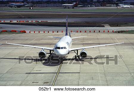 Stock Image - Plane Taxiing in an Airport. Fotosearch