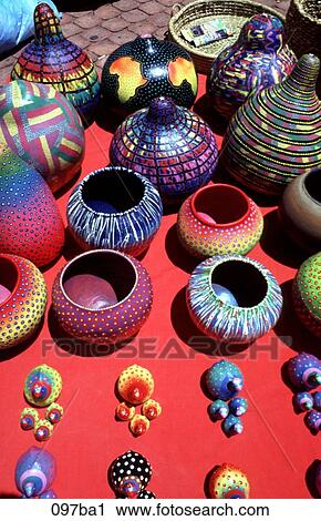Stock Image - Colourful Pots on Red Cloth Zimbabwe. Fotosearch