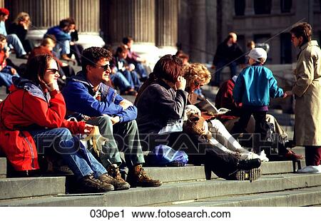 Stock Image - Group of Tourists Sitting on Steps. Fotosearch
