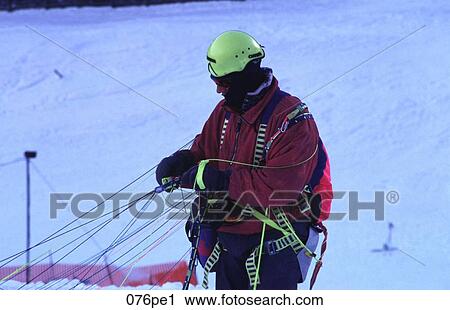 Man Disentangling Paraglider in the Snow Austria View Large Photo Image Stock Image - Man Disentangling Paraglider in the Snow Austria. Fotosearch