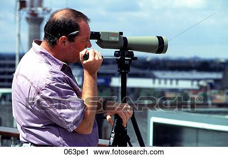 Man Looking Through a Short Telescope View Large Photo Image Stock Image - Man Looking Through a Short Telescope. Fotosearch