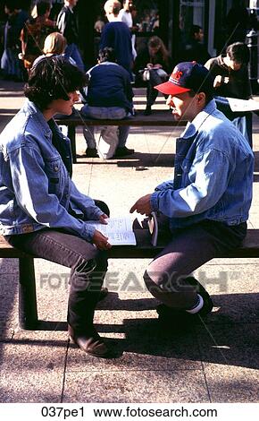 Stock Image - Teenagers Sitting on a Bench. Fotosearch