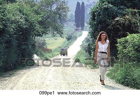 Woman Walking along Country Lane Italy View Large Photo Image Stock Image - Woman Walking along Country Lane Italy. Fotosearch