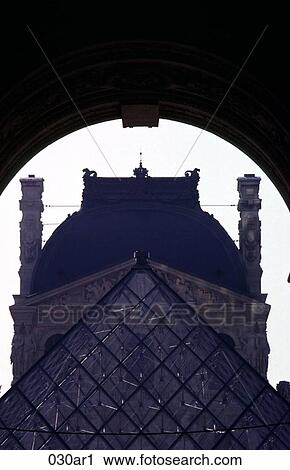 Stock Image - View through Arch of Pyramid Outside La Louvre Paris. Fotosearch